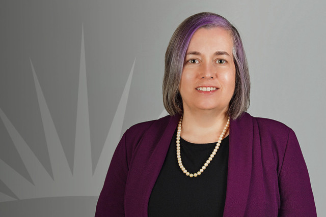 Headshot of Laura Maxwell with sunburst in background